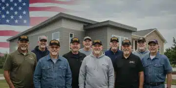 Veterans smiling in front of a modern community center and new housing, symbolizing updated benefits and support.