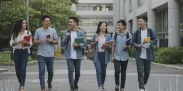 Students on a university campus discussing educational reimbursement benefits and financial aid opportunities.